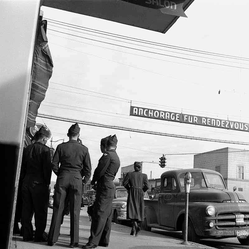 Soldiers watching a woman walking by