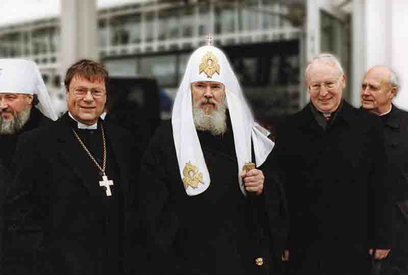 Patriarch Alexius II and a group of German clergymen in black robes.