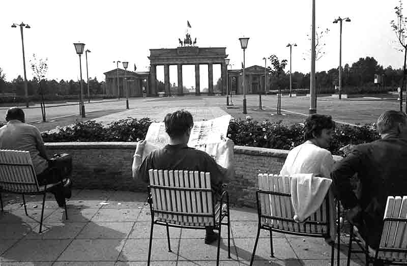 Man reading Newspaper at Brandenburg Gate Berlin