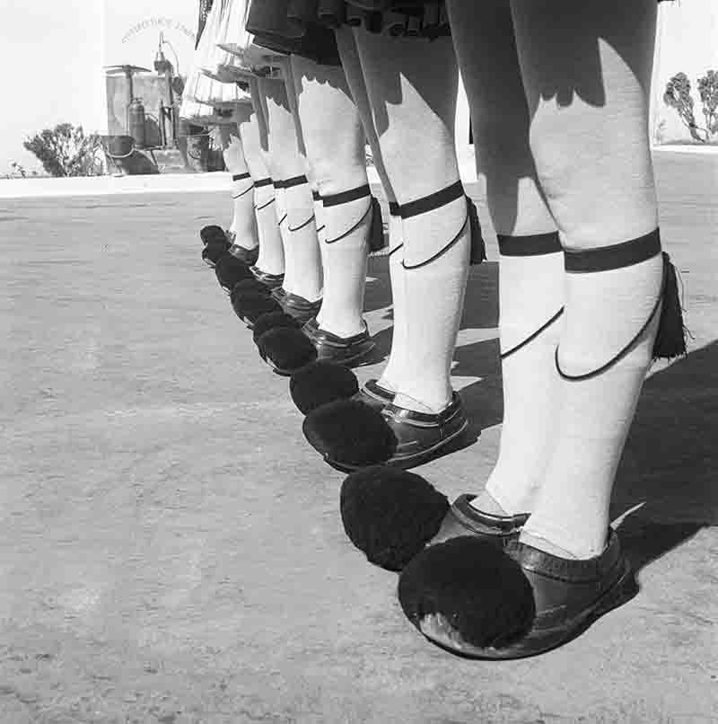 A closeup of the woolen tights and shoes with pompoms of a member of the  Evzones guarding the tomb of the unknown soldier Stock Photo - Alamy