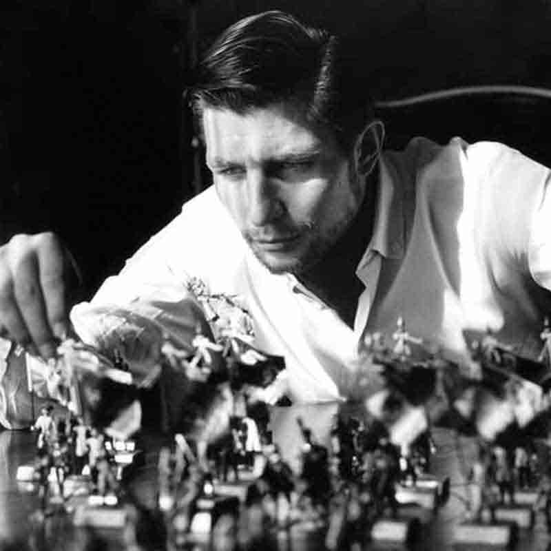 Gunther Sachs Gunter Sachs focused on a chess game, strategically moving miniature chess pieces on a small board.