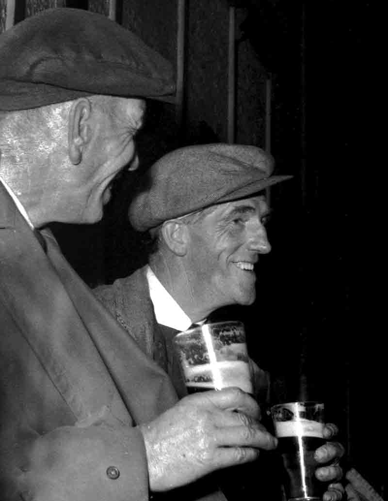 2 men drinking Guiness in an Irish Pub