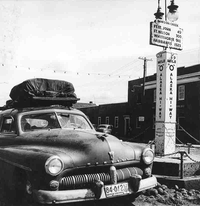 Mercury Eight Sedan at a Signpost on the Alaska Highway