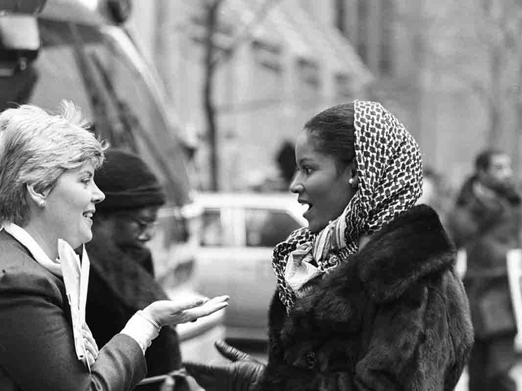 Two women having a conversation on the strees of New York