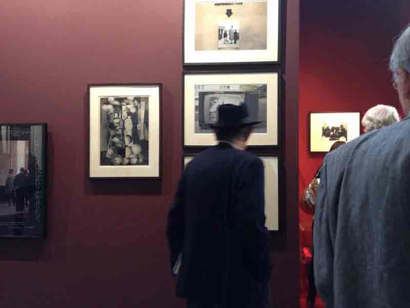 Man looking at photographs in exhibition