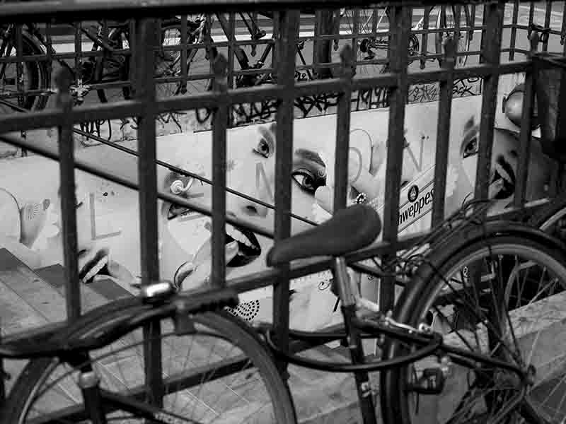 Bicycles at a Paris subway station with Schweppes advertising in the background