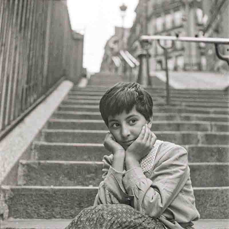 Girl sitting on steps in Paris