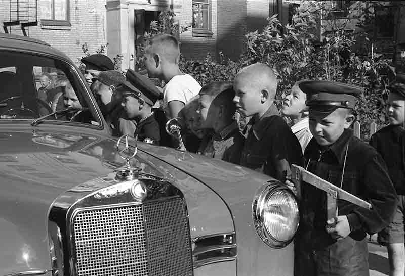 Playing children in Moscow admiring a Mercedes Benz