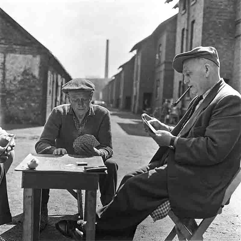 Men playing cards outdoors