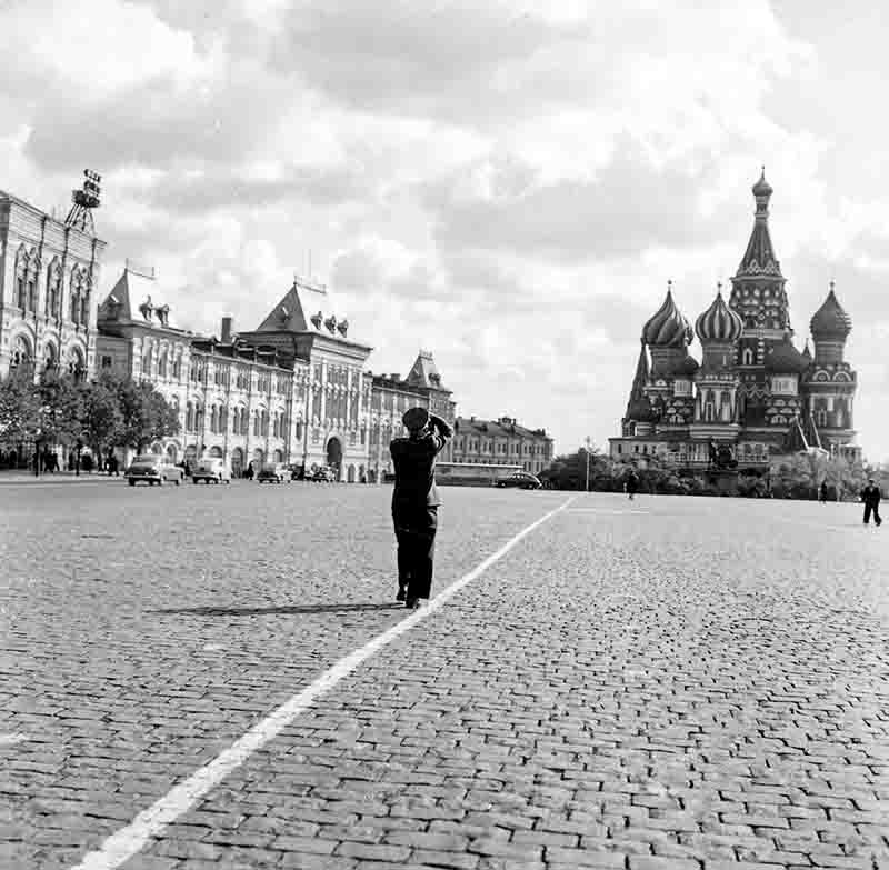 Soldier in uniform photographs the Saint Basil's Cathedral on the red square in Moscow