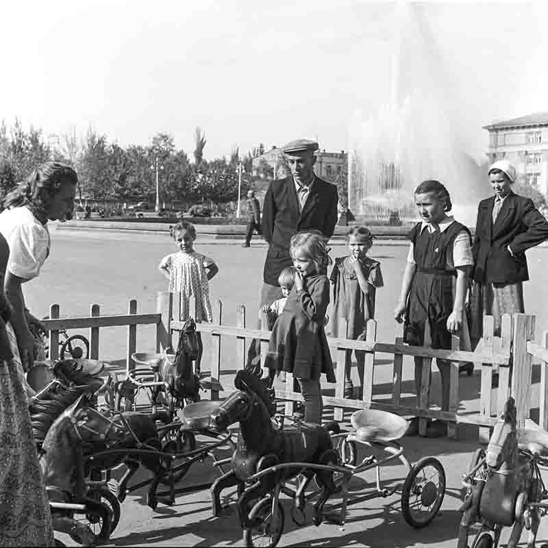 Soviet family at an outdoor market for wooden toys