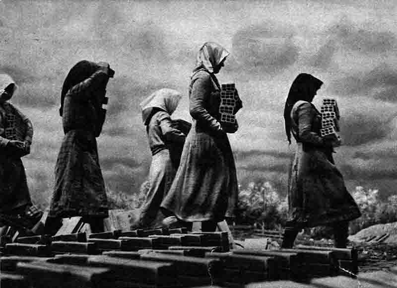 Women in Greece carrying clay bricks